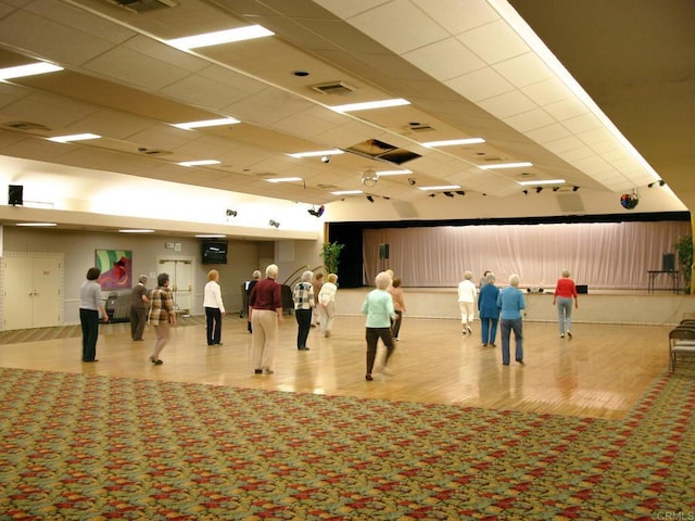 interior space with light wood-style flooring, visible vents, and a drop ceiling