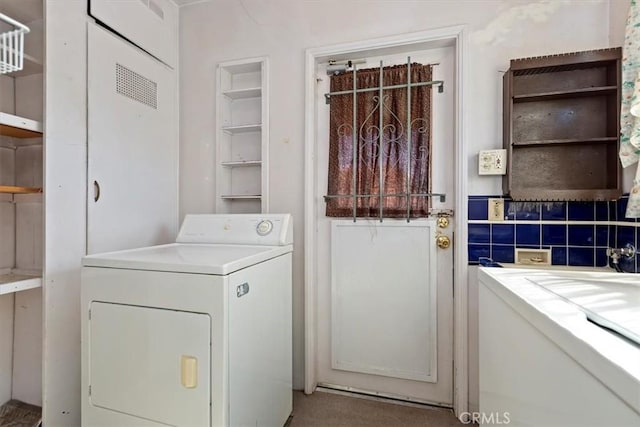 laundry area with laundry area and washer / dryer