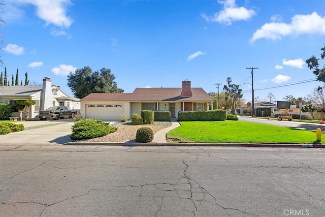 ranch-style house featuring a garage, driveway, and a front lawn