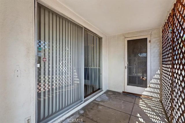 doorway to property featuring stucco siding