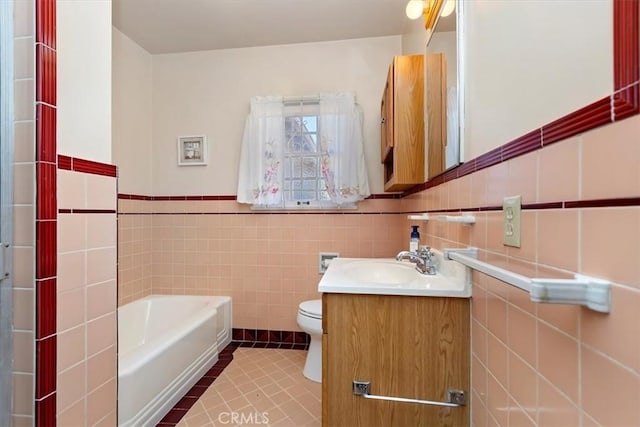 bathroom featuring toilet, tile walls, vanity, a bath, and tile patterned floors