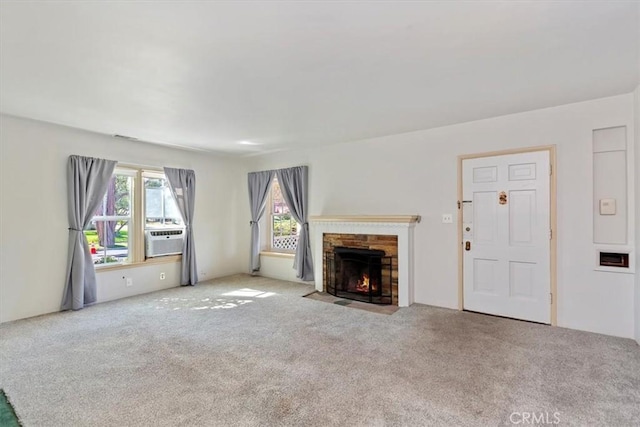 unfurnished living room featuring light carpet, a fireplace, and cooling unit