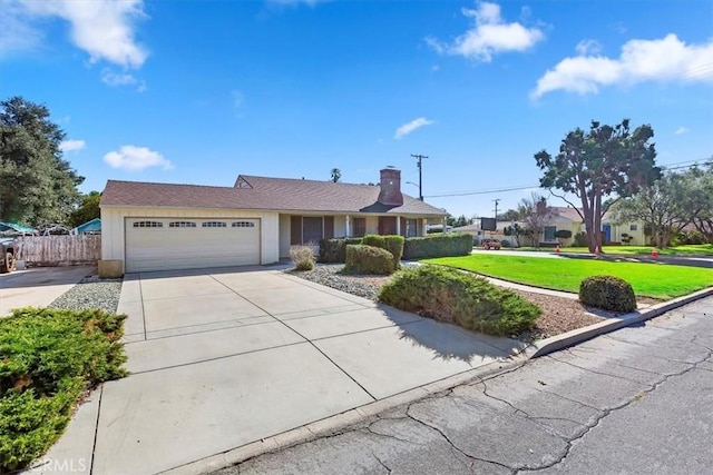 single story home featuring an attached garage, fence, driveway, a front lawn, and a chimney