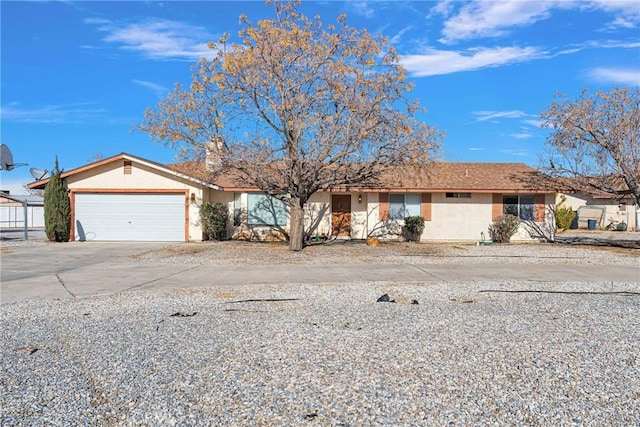 ranch-style house with driveway, an attached garage, and stucco siding