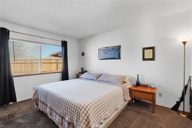 bedroom featuring a textured ceiling and carpet floors