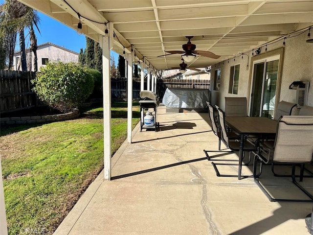 view of patio featuring outdoor dining area, a fenced backyard, and ceiling fan