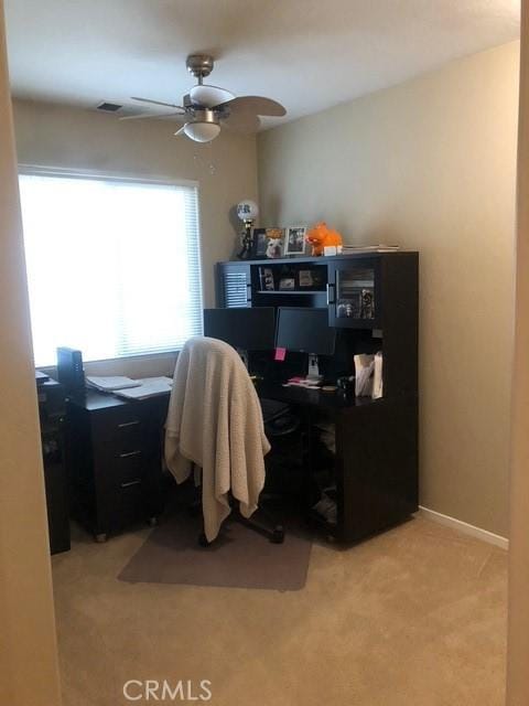 office area with ceiling fan, visible vents, and light colored carpet