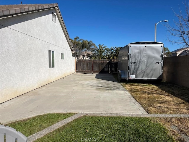 view of home's exterior featuring a patio area, fence, and stucco siding