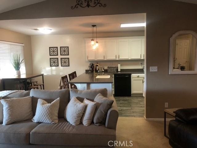 living area with carpet floors and vaulted ceiling