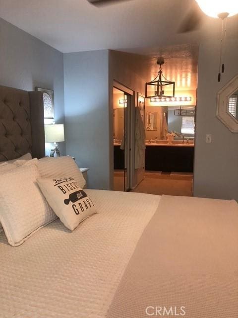 bedroom featuring an inviting chandelier