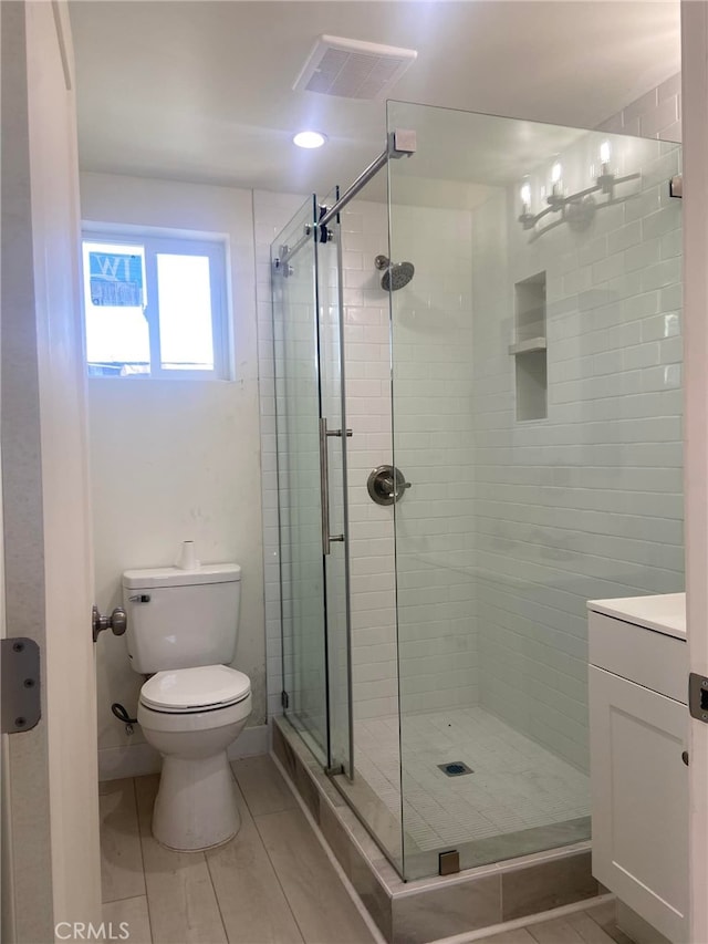 full bath featuring toilet, visible vents, and a stall shower