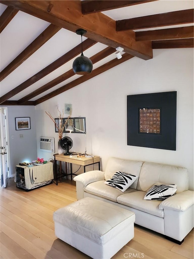 living area with an AC wall unit, vaulted ceiling with beams, and wood finished floors