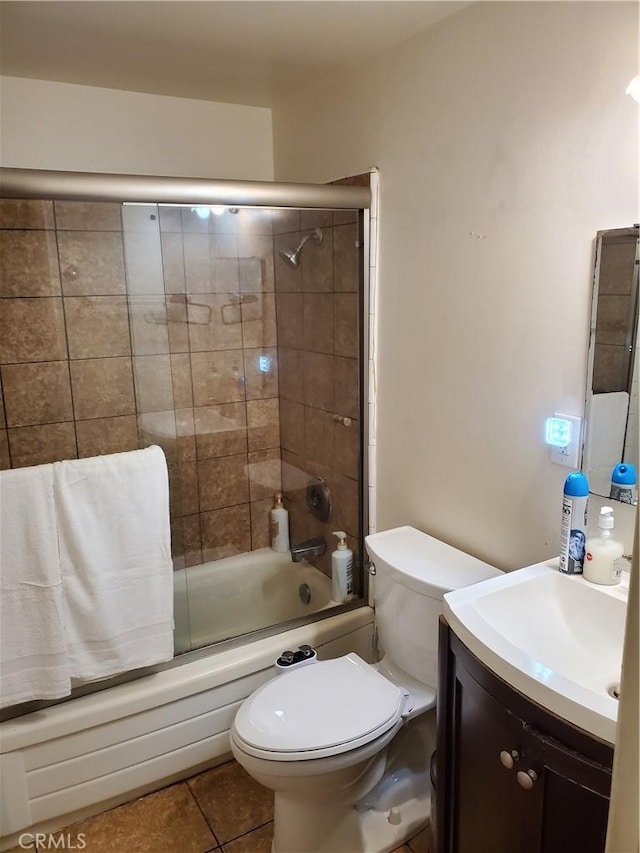 full bathroom featuring enclosed tub / shower combo, tile patterned flooring, toilet, and vanity