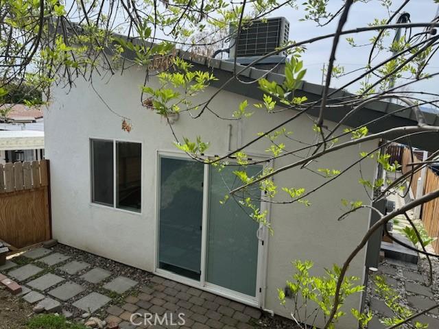exterior space featuring a patio, fence, and stucco siding