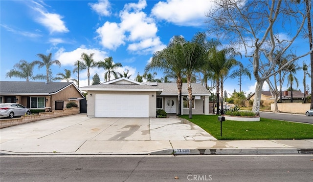 ranch-style home featuring driveway, a front yard, an attached garage, and stucco siding