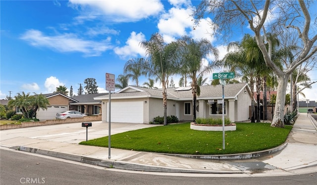 ranch-style house featuring an attached garage, concrete driveway, a front yard, and stucco siding