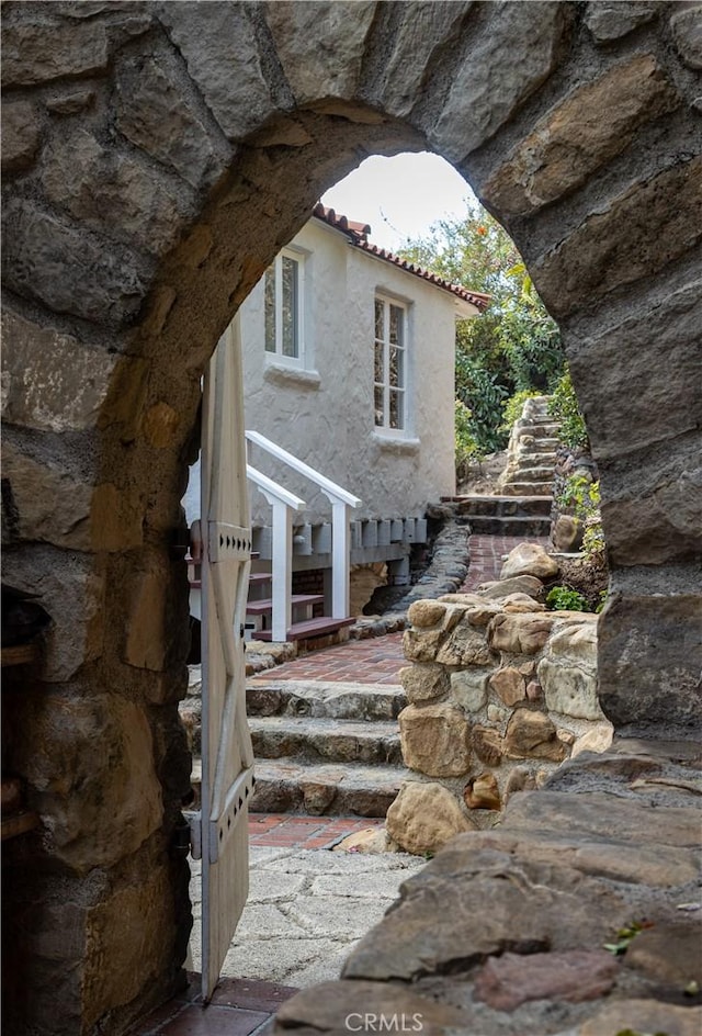 exterior space featuring a tiled roof and stucco siding