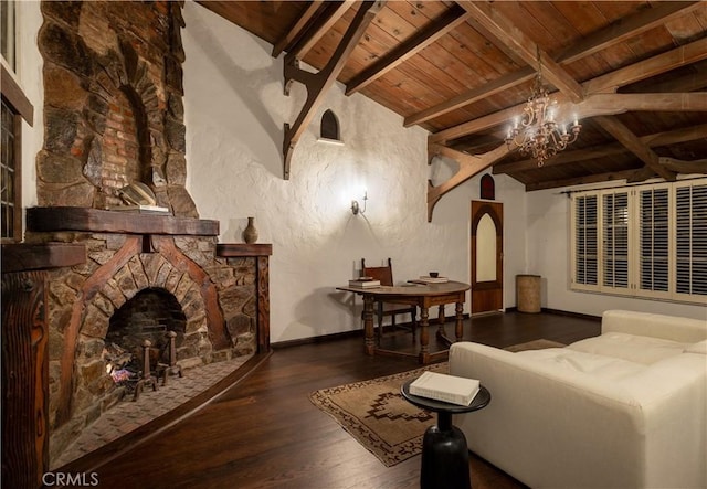 interior space with dark wood-style flooring, vaulted ceiling with beams, an inviting chandelier, a stone fireplace, and wooden ceiling