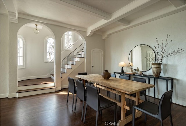 dining area featuring baseboards, stairway, dark wood-style flooring, a chandelier, and beam ceiling