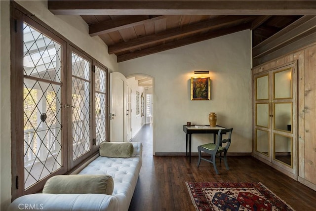 sitting room featuring dark wood-type flooring, arched walkways, wood ceiling, and vaulted ceiling with beams