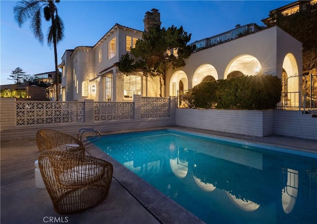 view of swimming pool featuring a fenced in pool, a patio, and fence