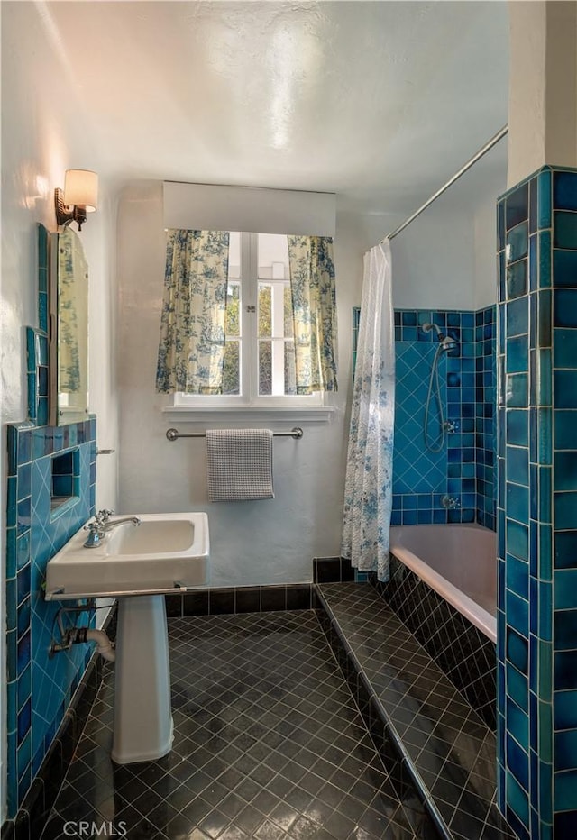 full bath featuring tiled shower / bath combo and tile patterned floors