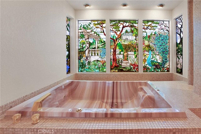 interior details with a jacuzzi and a textured wall