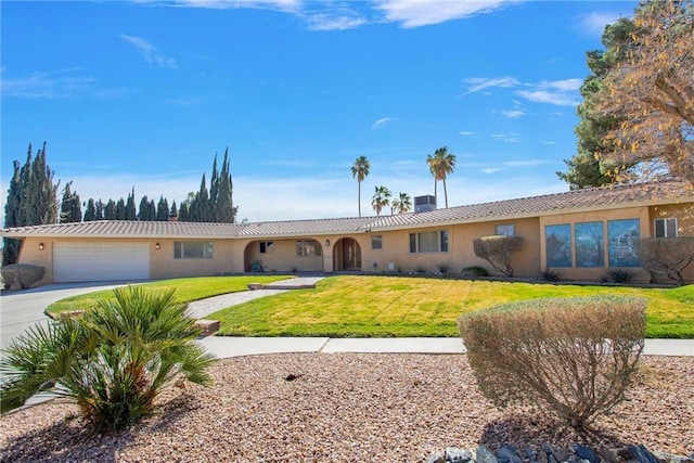 ranch-style house featuring a garage, concrete driveway, central air condition unit, a front yard, and stucco siding