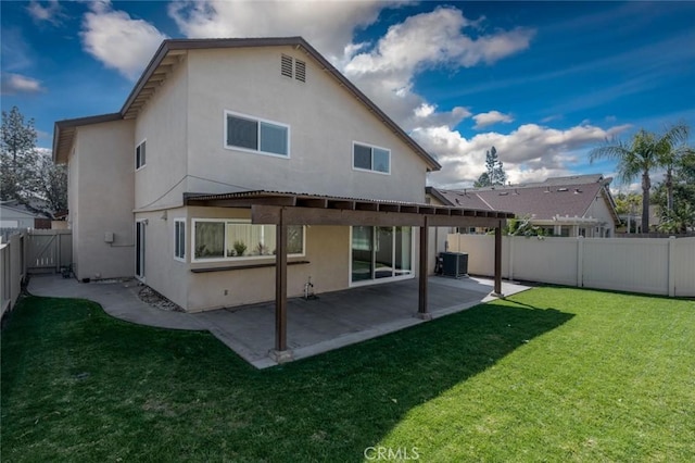 rear view of property with central AC unit, a lawn, a patio, a fenced backyard, and stucco siding