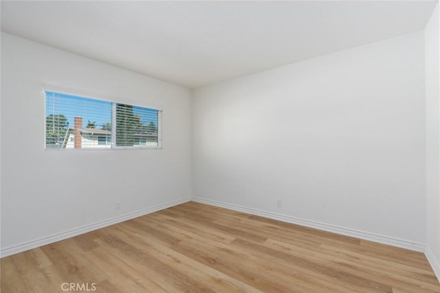 unfurnished room featuring light wood-style flooring and baseboards