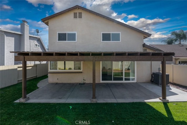 back of house featuring a patio, cooling unit, a fenced backyard, and stucco siding