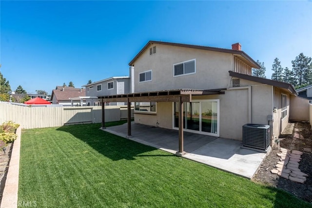 rear view of property with a fenced backyard, a yard, a patio area, central AC, and stucco siding