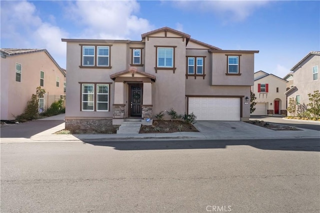 view of front of home featuring a garage, concrete driveway, and stucco siding