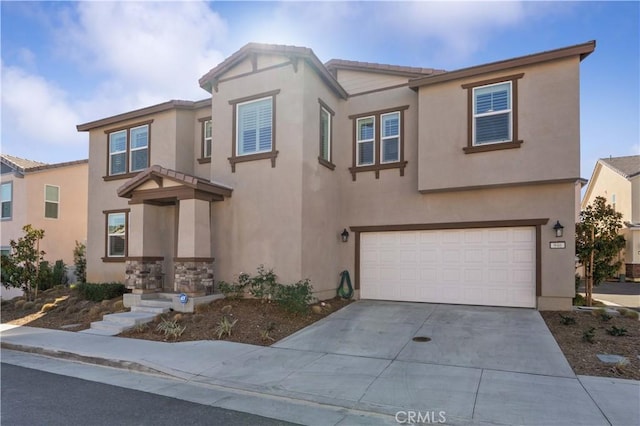 view of front of property with an attached garage, driveway, a tiled roof, and stucco siding