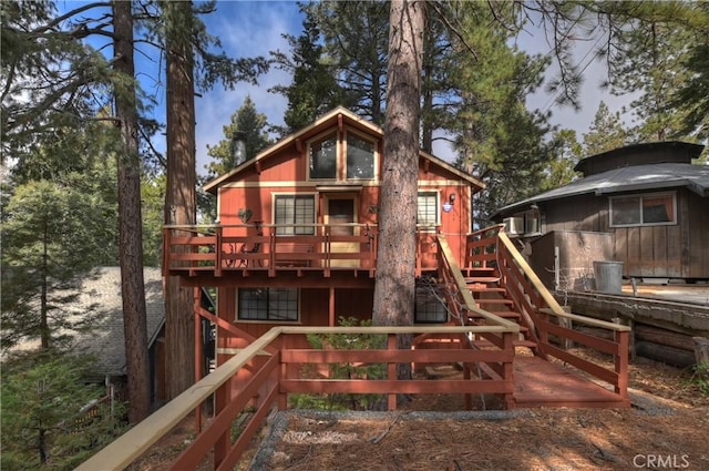 view of play area with stairway and a deck