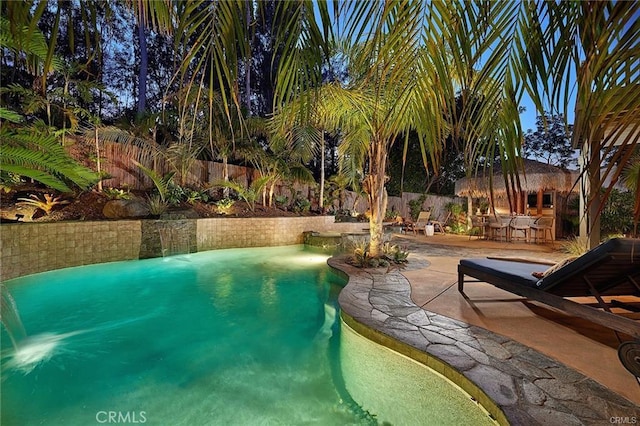 view of swimming pool featuring a patio area, a fenced backyard, and a fenced in pool