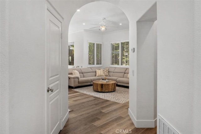 living room featuring recessed lighting, visible vents, ornamental molding, ceiling fan, and wood finished floors