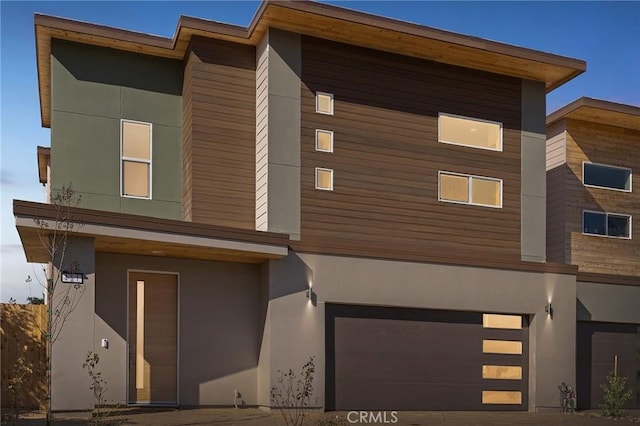 modern home featuring an attached garage and stucco siding