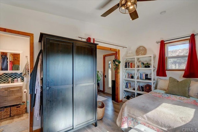 bedroom with ceiling fan, light wood finished floors, and a closet