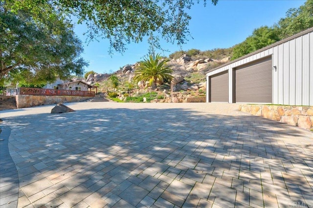 deck with an outbuilding and a garage