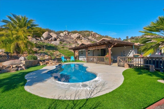 view of pool with a lawn, a pergola, a fenced in pool, and a patio area