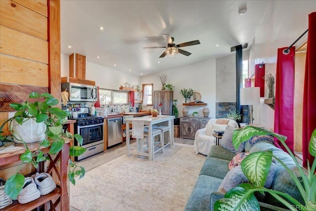 kitchen with recessed lighting, stainless steel appliances, ceiling fan, light wood-type flooring, and open floor plan