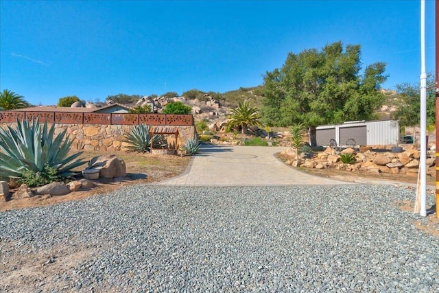 view of street with concrete driveway
