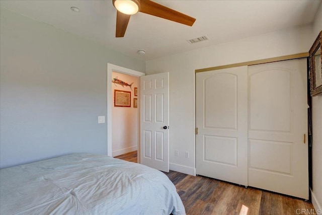 bedroom featuring a closet, visible vents, ceiling fan, and wood finished floors