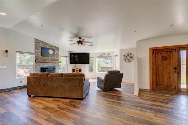living area featuring ceiling fan, baseboards, vaulted ceiling, a fireplace, and wood finished floors