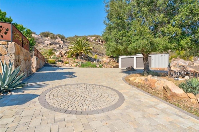 exterior space featuring curved driveway and fence