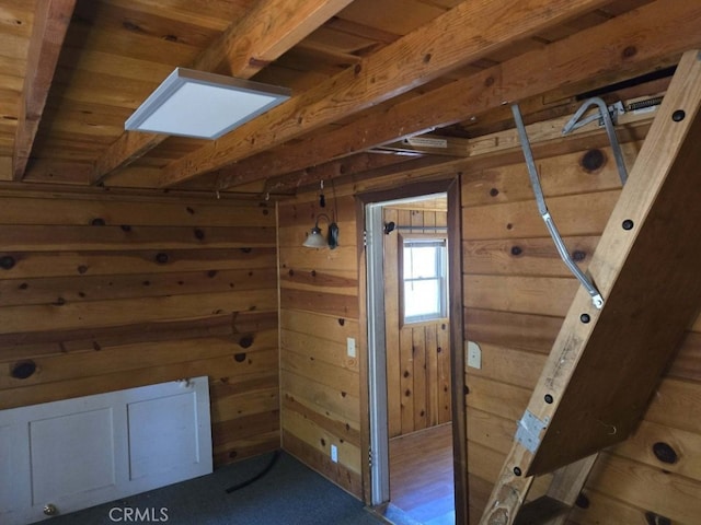 bonus room featuring wood walls