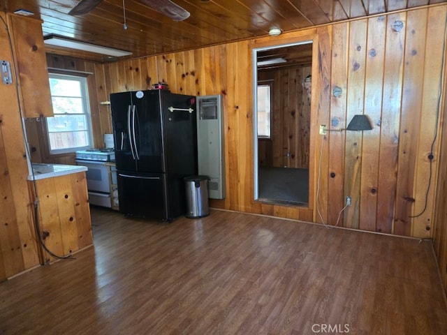 kitchen featuring wooden ceiling, light countertops, black fridge, and range with gas stovetop