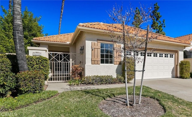 view of front of house featuring an attached garage, a tile roof, concrete driveway, and stucco siding