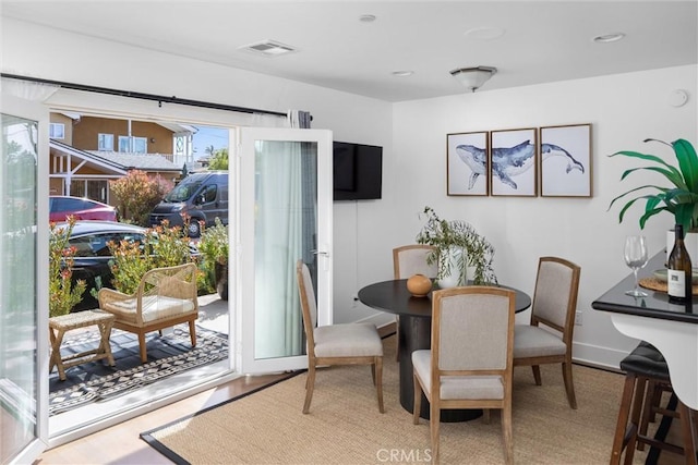 dining space featuring baseboards and visible vents